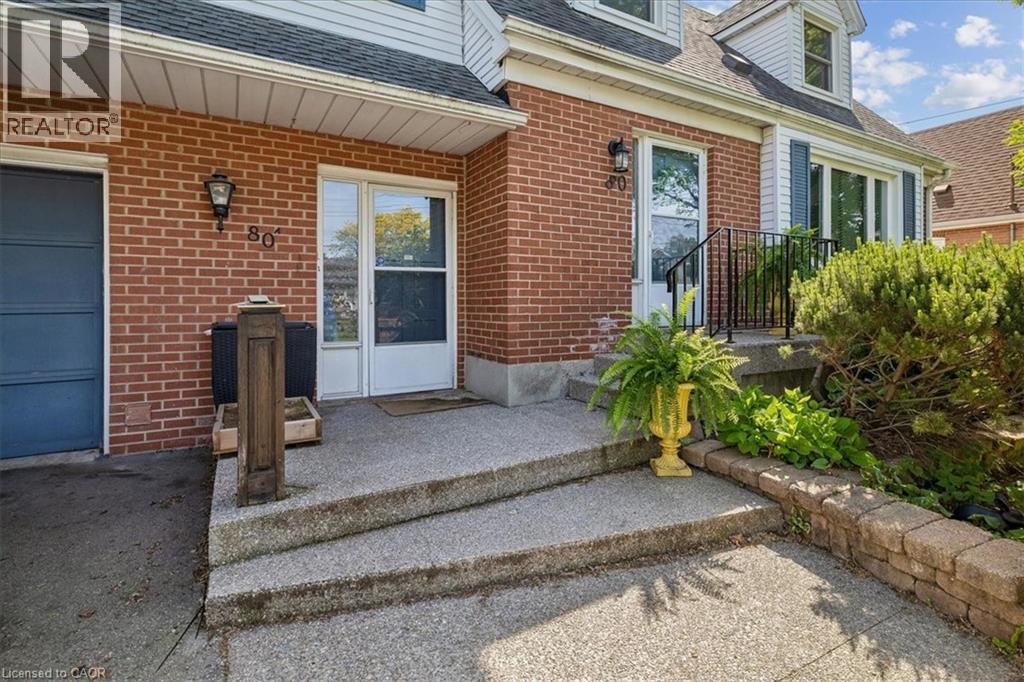 Brick exterior with white siding accents and a black shingle roof - 80 Maclennan Avenue, Hamilton, ON - Outdoor With Exterior