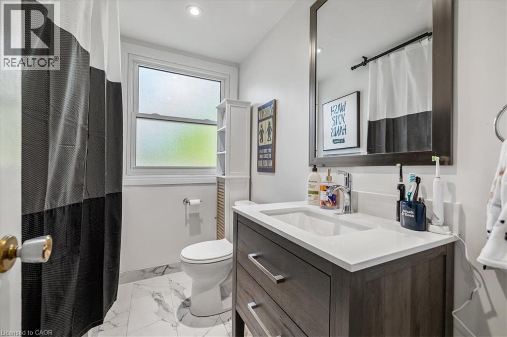 Vanity with a rectangular undermount sink, a white countertop, and chrome faucet - 80 Maclennan Avenue, Hamilton, ON - Indoor Photo Showing Bathroom
