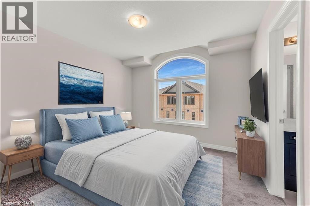 Room featuring an arched window, soft gray wall paint, and recessed ceiling details - 19 Picardy Drive Unit# 9, Hamilton, ON