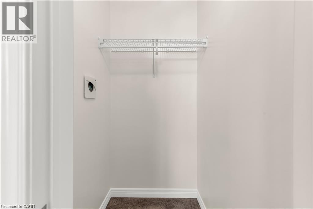 White-painted walls with white baseboards, a single wire shelf, and brown carpet flooring - 19 Picardy Drive Unit# 9, Hamilton, ON