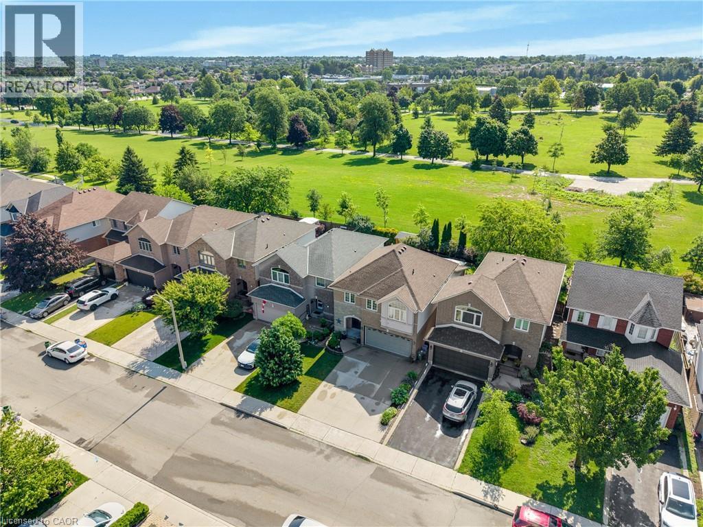 Aerial perspective showcasing residential properties bordering a manicured green space - 409 Jacqueline Boulevard, Hamilton, ON