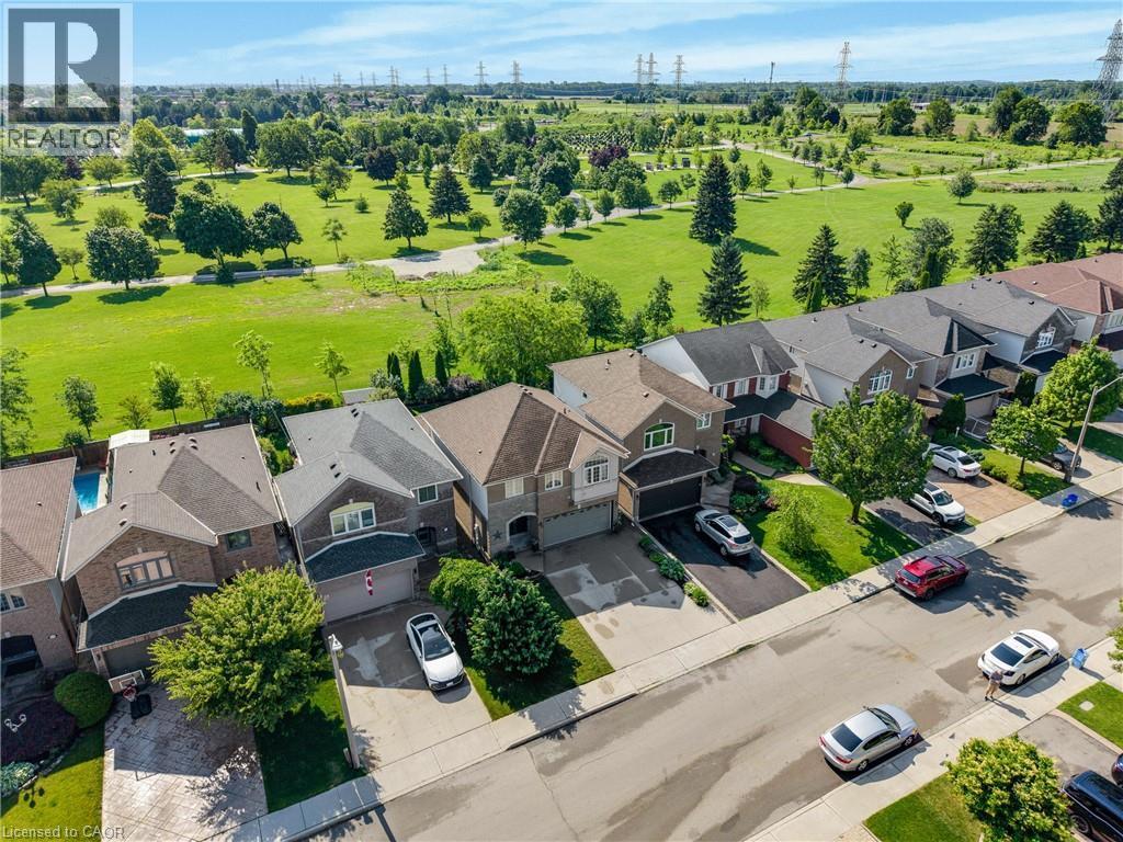Residential neighborhood featuring a paved street and multiple detached homes with various architectural styles - 409 Jacqueline Boulevard, Hamilton, ON