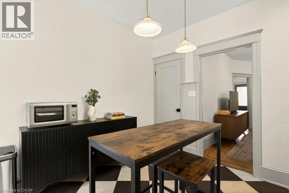Kitchen space featuring black and white checkered flooring - 148 Dundurn Street N, Hamilton, ON