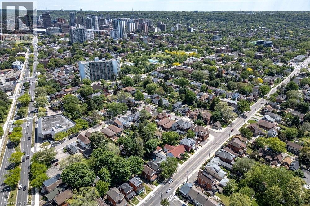 Expansive aerial capture showcasing a dense residential area with mature tree canopy - 148 Dundurn Street N, Hamilton, ON