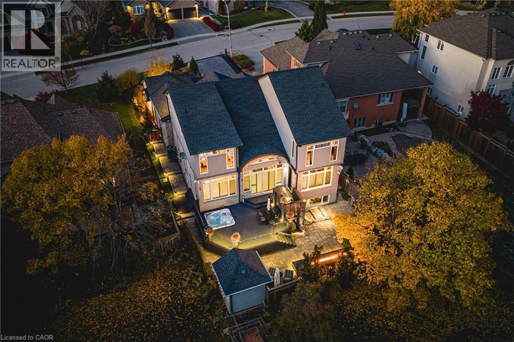 Expansive rear patio featuring integrated lighting, a built-in hot tub, and a detached shed - 712 Highvalley Road, Ancaster, ON