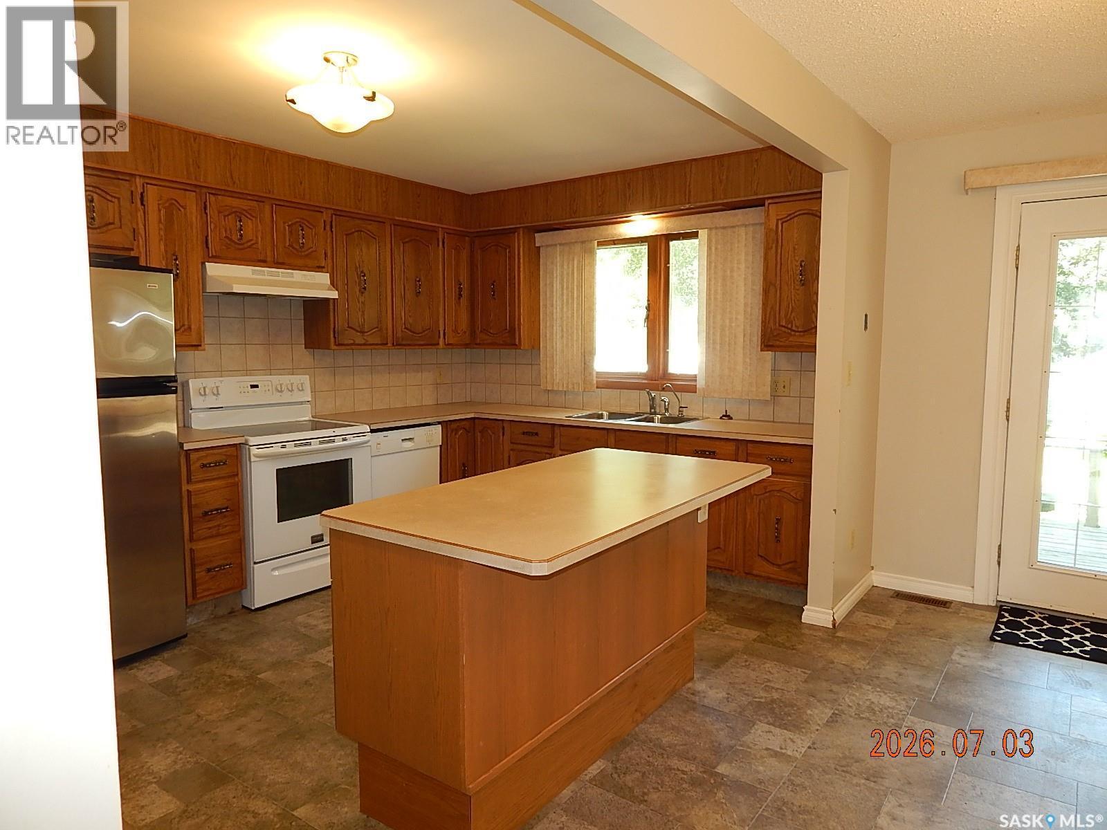 710 3Rd Street E, Assiniboia, SK - Indoor Photo Showing Kitchen With Double Sink