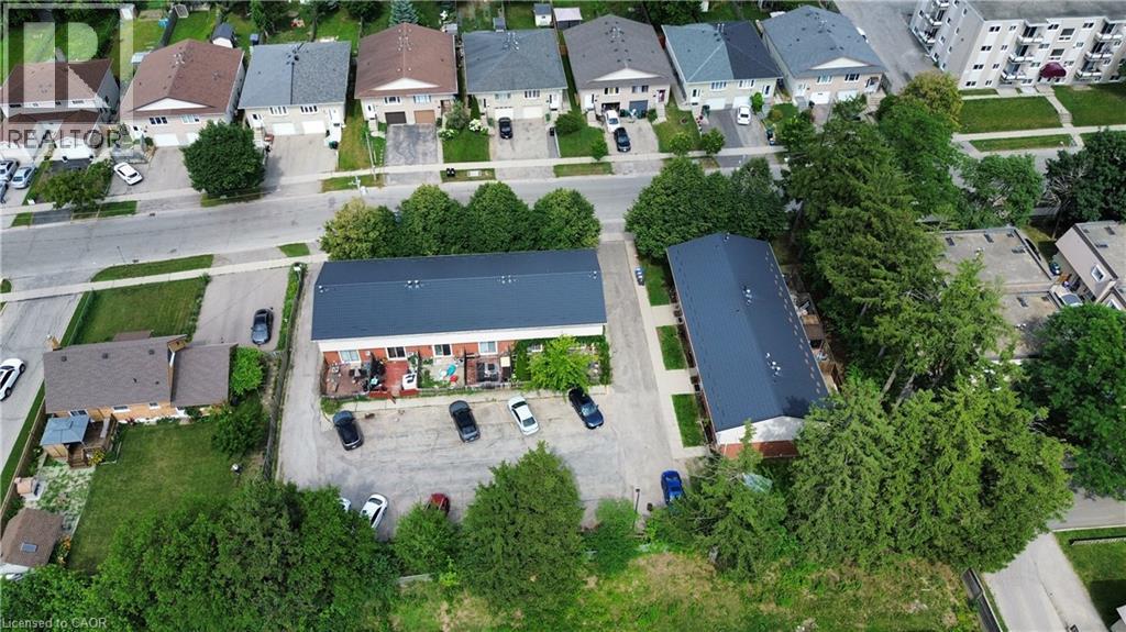 Aerial perspective showcasing two multi-unit buildings with dark roofs - 181 Thaler Avenue, Kitchener, ON