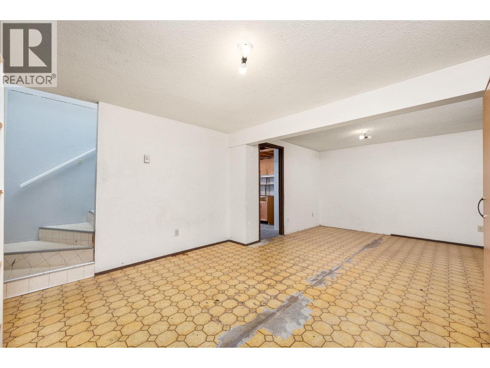 Basement rec room - flooring is now replaced with laminate - 5008 Heritage Drive, Vernon, BC - Indoor Photo Showing Other Room