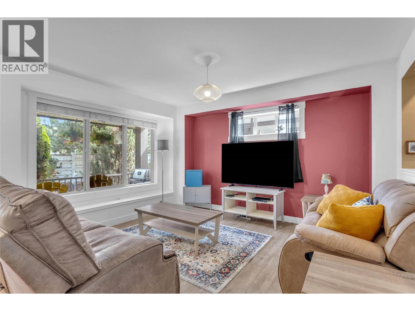 Nice, bright living room with the window looking out onto the front deck. - 128-1651 Lynrick Road, Kelowna, BC