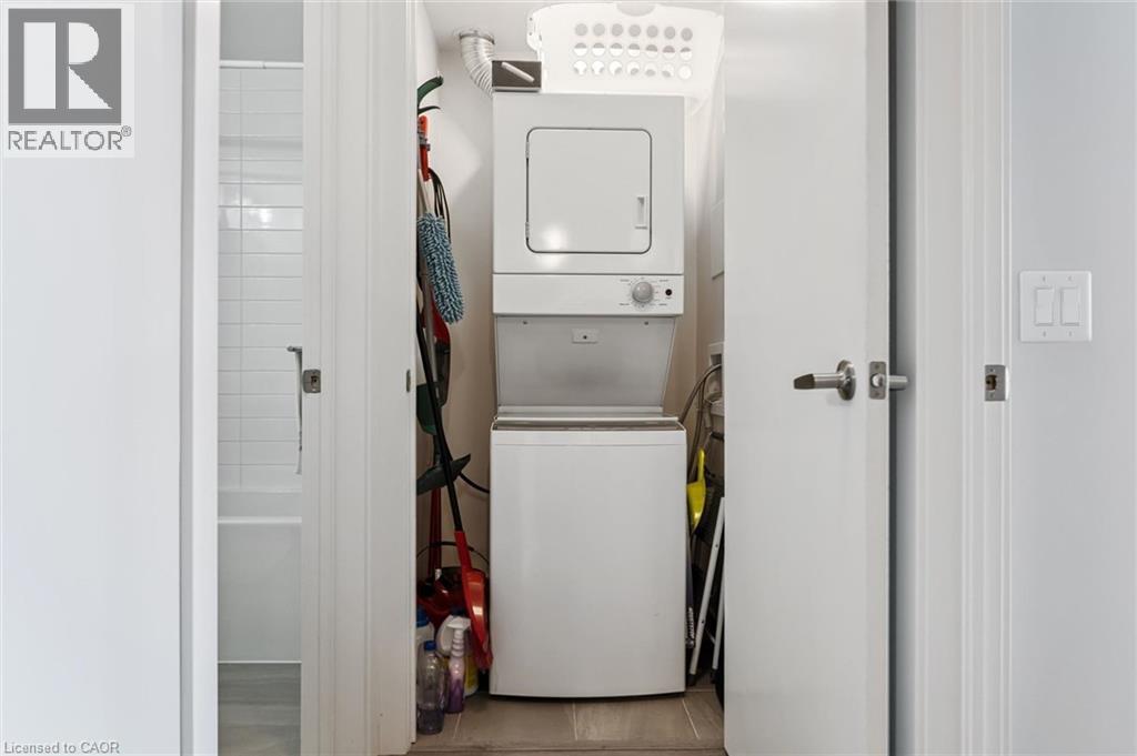 Dedicated laundry closet featuring a stacked washer and dryer unit - 340 Plains Road E Unit# 507, Burlington, ON - Indoor Photo Showing Laundry Room