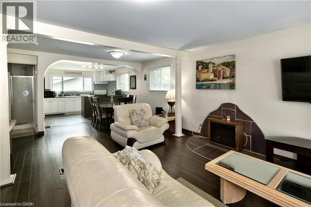 Open-concept living area featuring dark wood-finish flooring - 42 5Th Lane, Wasaga Beach, ON - Indoor Photo Showing Living Room
