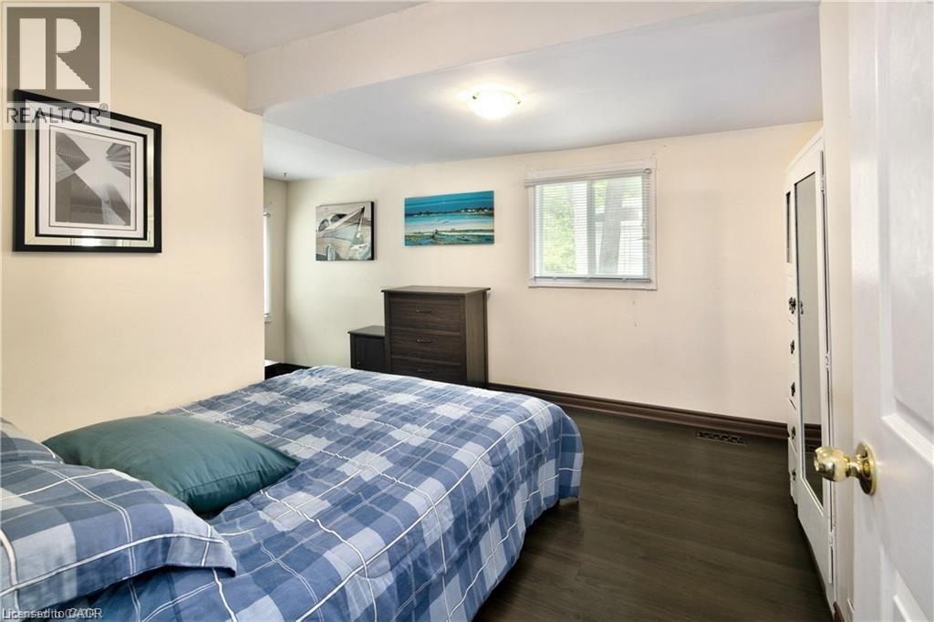 Neutral wall paint featuring a window with a roller shade - 42 5Th Lane, Wasaga Beach, ON - Indoor Photo Showing Bedroom