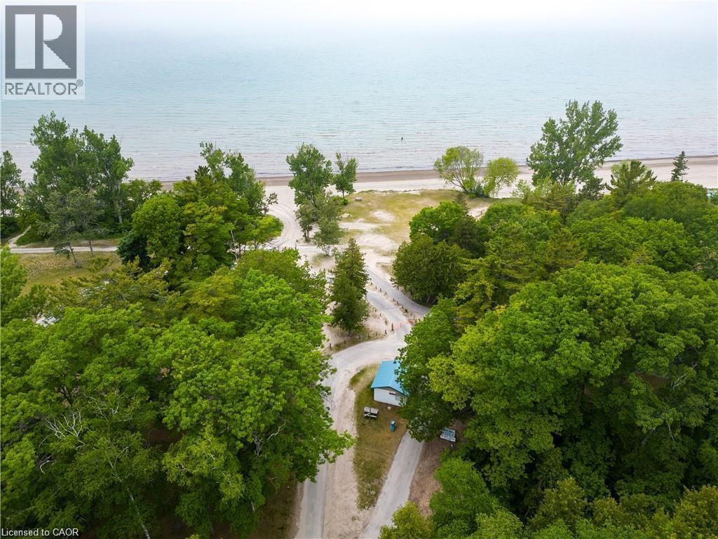 Aerial perspective showcasing a shoreline property with extensive tree coverage - 42 5Th Lane, Wasaga Beach, ON - Outdoor With View