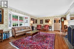 Living room with bay windows trees in front & back - 