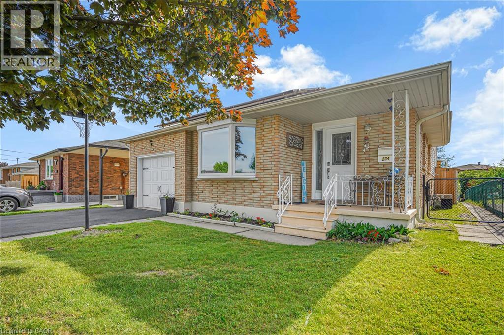 Brick exterior with a prominent bay window, attached garage, covered front porch, and a paved driveway - 234 Thunderbird Drive, Cambridge, ON - Outdoor With Deck Patio Veranda
