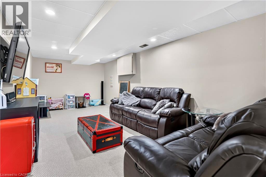 Finished lower level featuring recessed lighting, a drop ceiling, light neutral wall tones, and carpeting - 234 Thunderbird Drive, Cambridge, ON - Indoor Photo Showing Basement