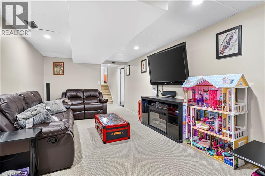 Carpeted recreational room featuring recessed lighting and a media center with an electric fireplace - 234 Thunderbird Drive, Cambridge, ON - Indoor Photo Showing Basement