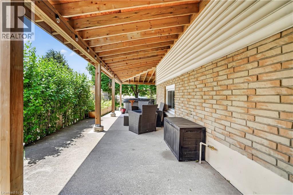 Expansive covered patio featuring a natural wood ceiling, exposed beams, and integrated lighting - 234 Thunderbird Drive, Cambridge, ON - Outdoor With Exterior