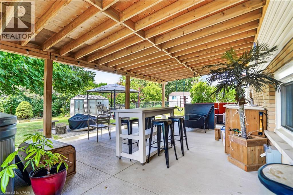 Expansive covered patio featuring a wood-finish ceiling, concrete flooring, and recessed lighting - 234 Thunderbird Drive, Cambridge, ON - Outdoor With Deck Patio Veranda