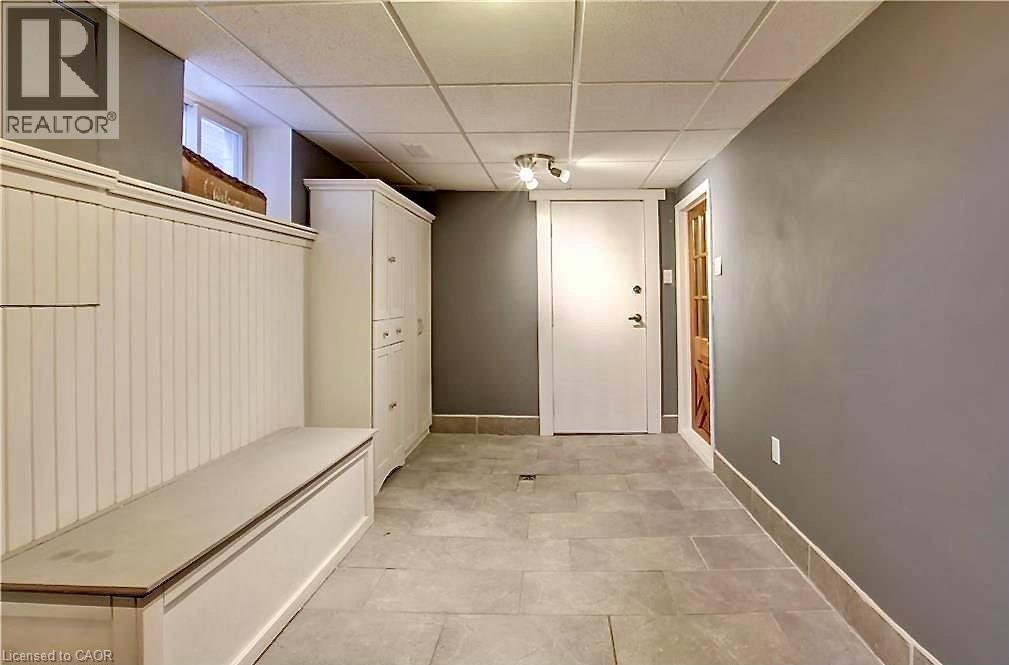 Entryway featuring built-in white cabinetry, beadboard paneling, and a storage bench - 599 Upper Horning Road Unit# Main/Upper, Hamilton, ON
