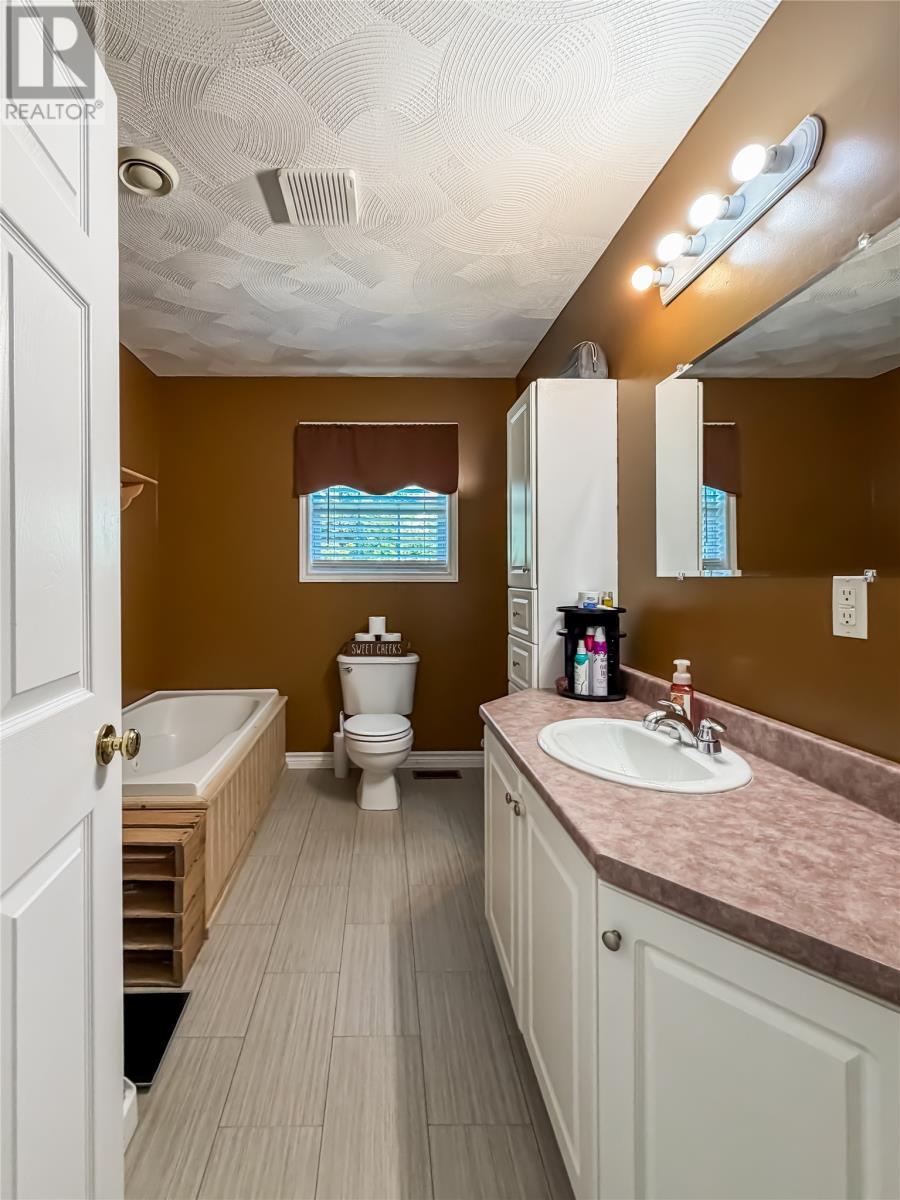 Main floor bathroom with jacuzzi tub and stand up shower - 100A Main Road, Lewin'S Cove, NL
