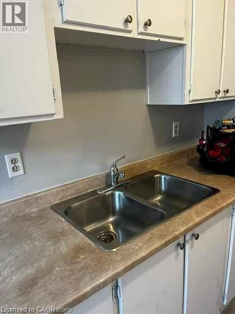 Kitchen sink with a dual basin stainless steel design and a chrome faucet - 529 Parkside Drive Unit# 7, Waterloo, ON