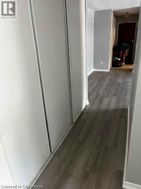 Hallway featuring wood-finish flooring and light gray walls - 529 Parkside Drive Unit# 7, Waterloo, ON
