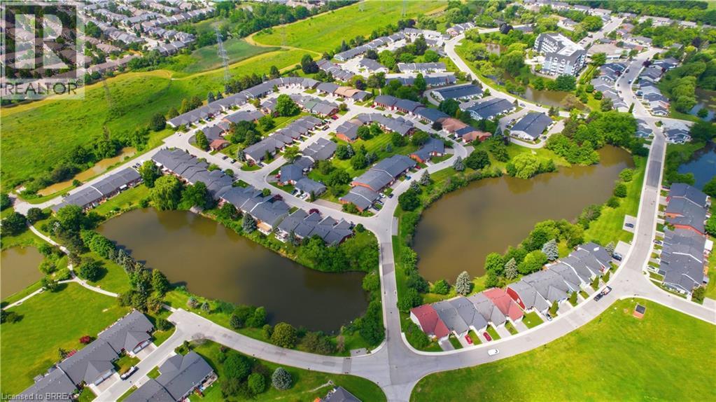 Residential development featuring a network of streets, surrounded by lush green spaces and multiple water features - 29 Archdeacon Clark Trail, Hamilton, ON