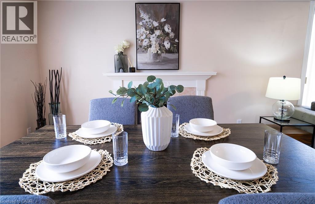 Dining area featuring a dark wood-finish table and upholstered chairs - 566 Avignon Place, Waterloo, ON