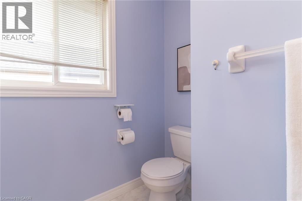 White toilet with a white seat - 566 Avignon Place, Waterloo, ON