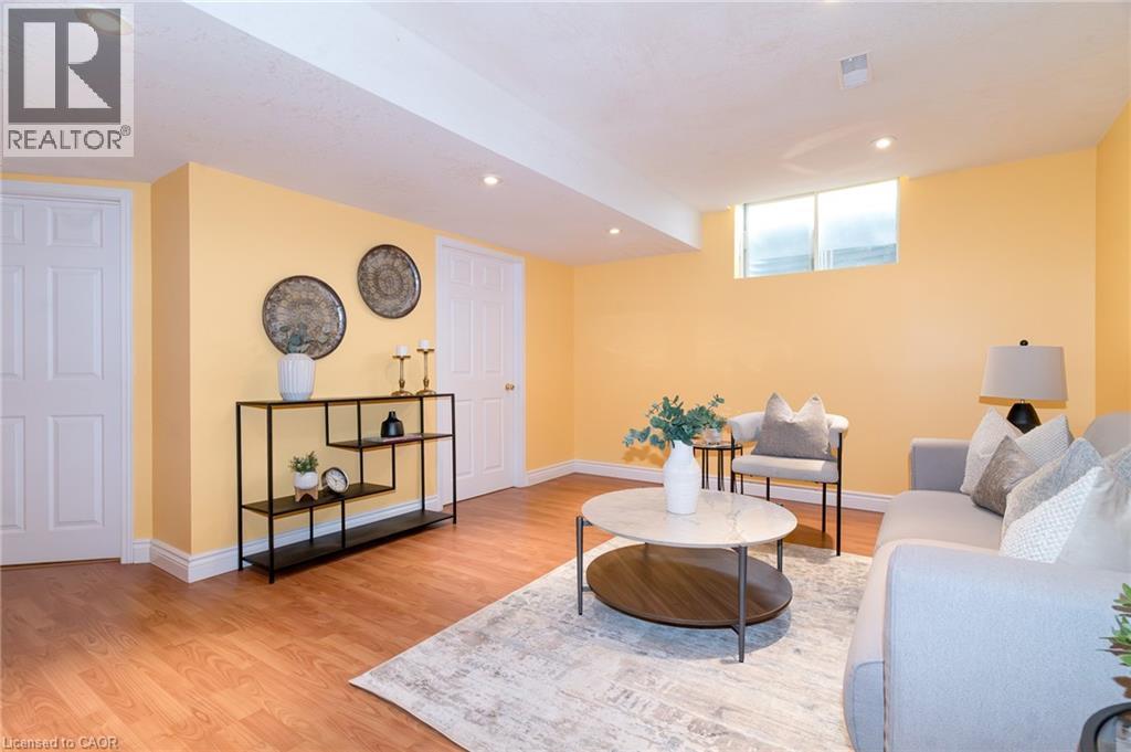Recreational room featuring wood-finish flooring, recessed lighting, and a window providing natural light - 566 Avignon Place, Waterloo, ON