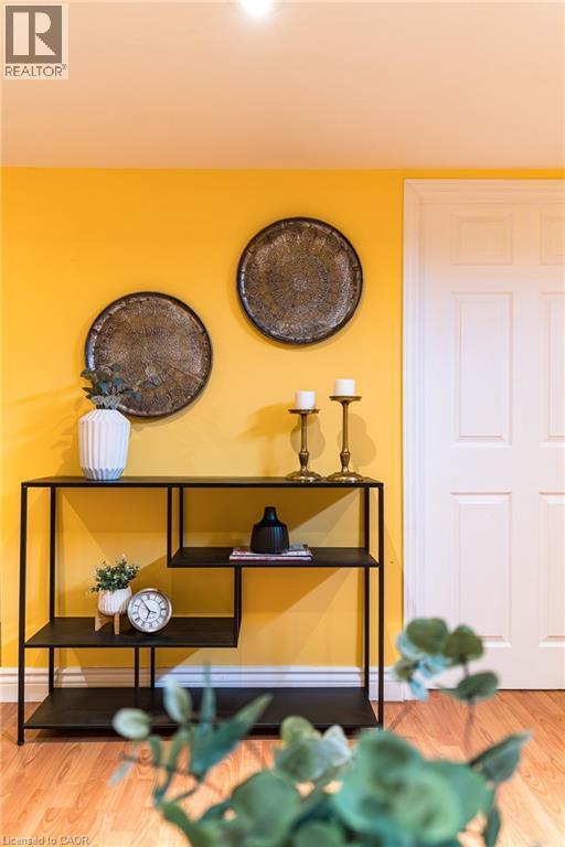 Warm yellow wall with wood-finish flooring - 566 Avignon Place, Waterloo, ON