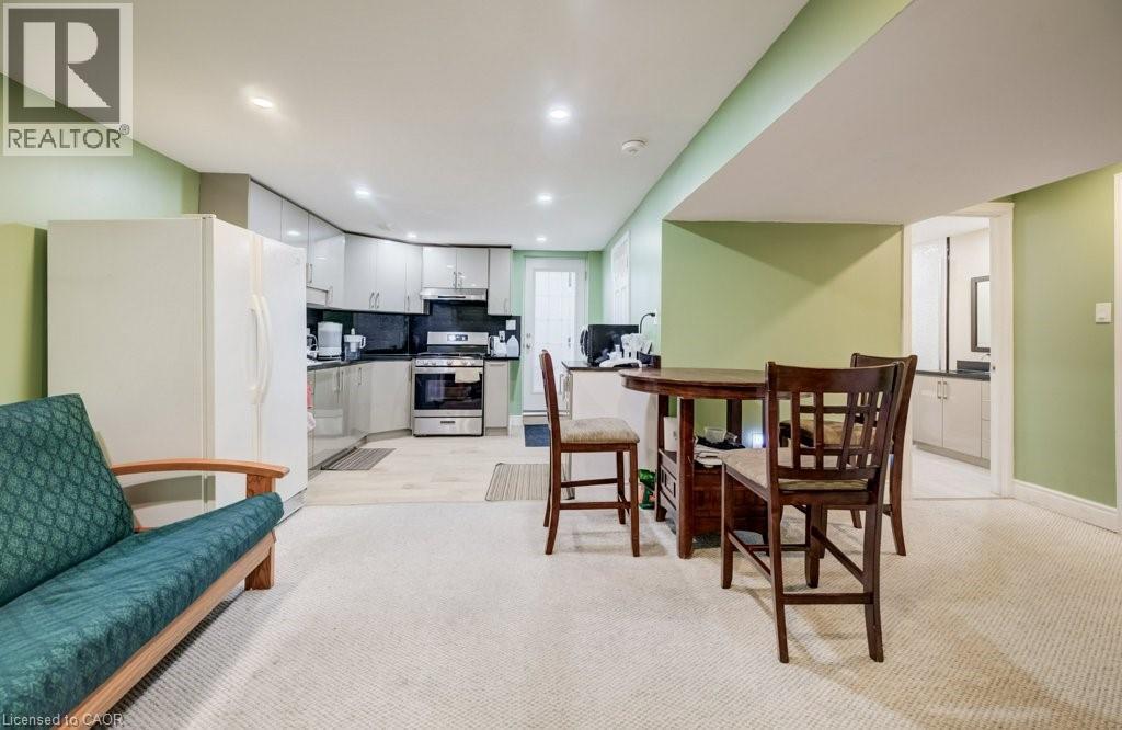 Kitchenette featuring gray cabinetry, black countertops, and stainless steel appliances - 123 Forest Edge Trail, Kitchener, ON