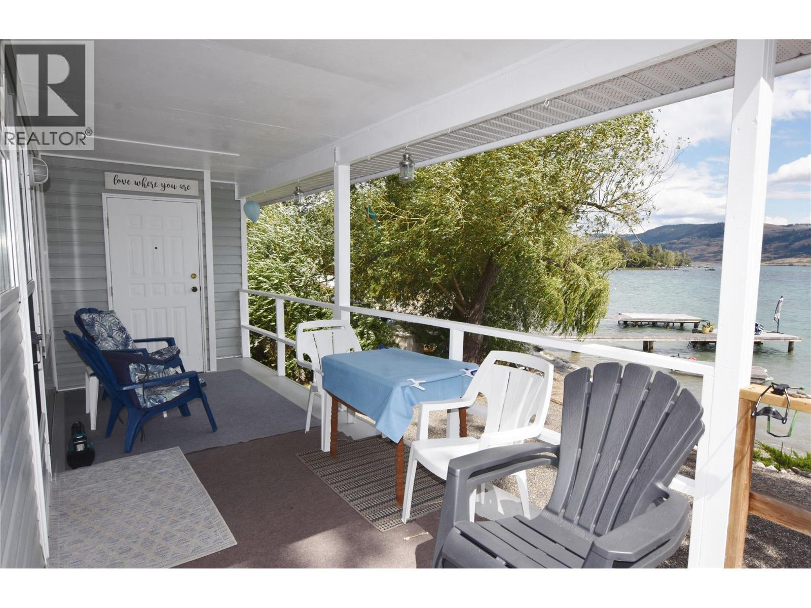 Front covered deck - 1 Imtil Road, Vernon, BC - Outdoor With Body Of Water With Deck Patio Veranda