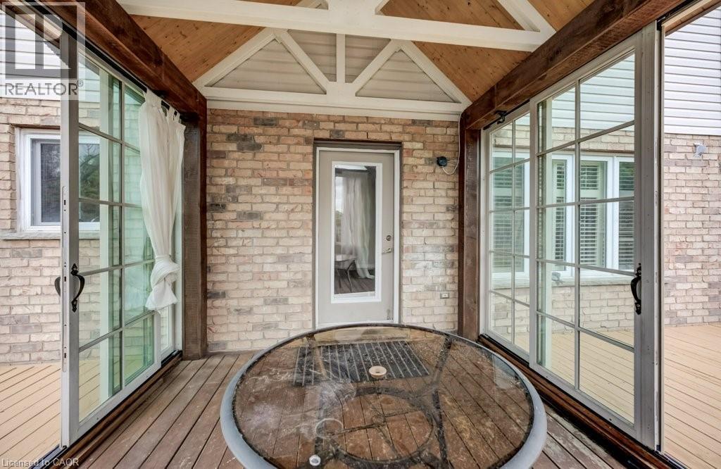 Covered outdoor patio with wood-finish flooring and exposed beam ceiling - 123 Forest Edge Trail, Kitchener, ON - With Exterior