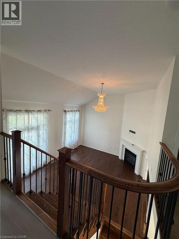 Two-story living area featuring a vaulted ceiling and a chandelier - 235 Apple Hill Crescent, Kitchener, ON