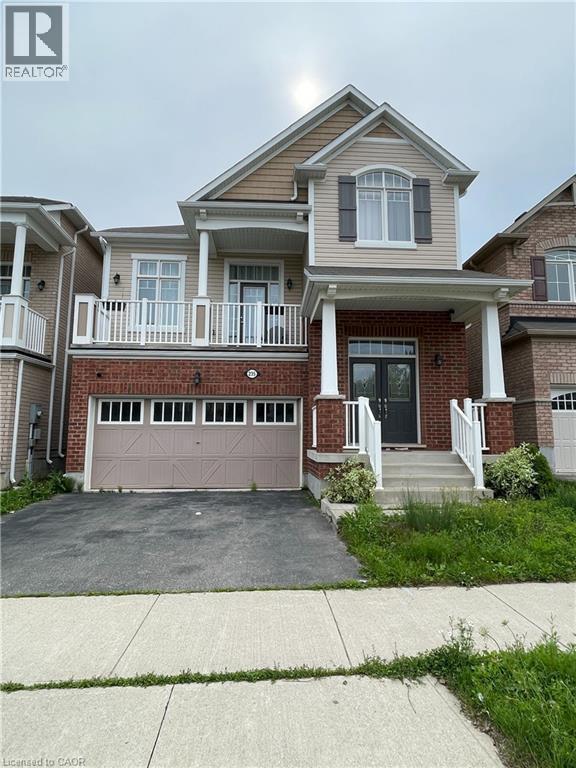 Two-story residence featuring a brick and siding facade, a double-door entry, and a covered front porch with white railings - 235 Apple Hill Crescent, Kitchener, ON