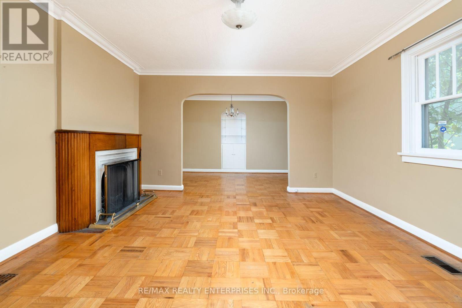 Main floor living room with wood burning fireplace - 52 Briarwood Avenue, Mississauga, ON