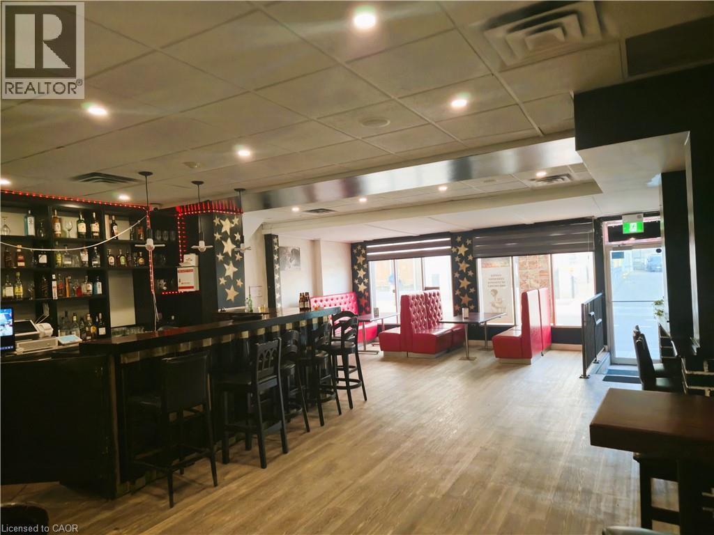Commercial interior featuring wood-finish flooring and recessed lighting - 30 Ontario Street S, Kitchener, ON