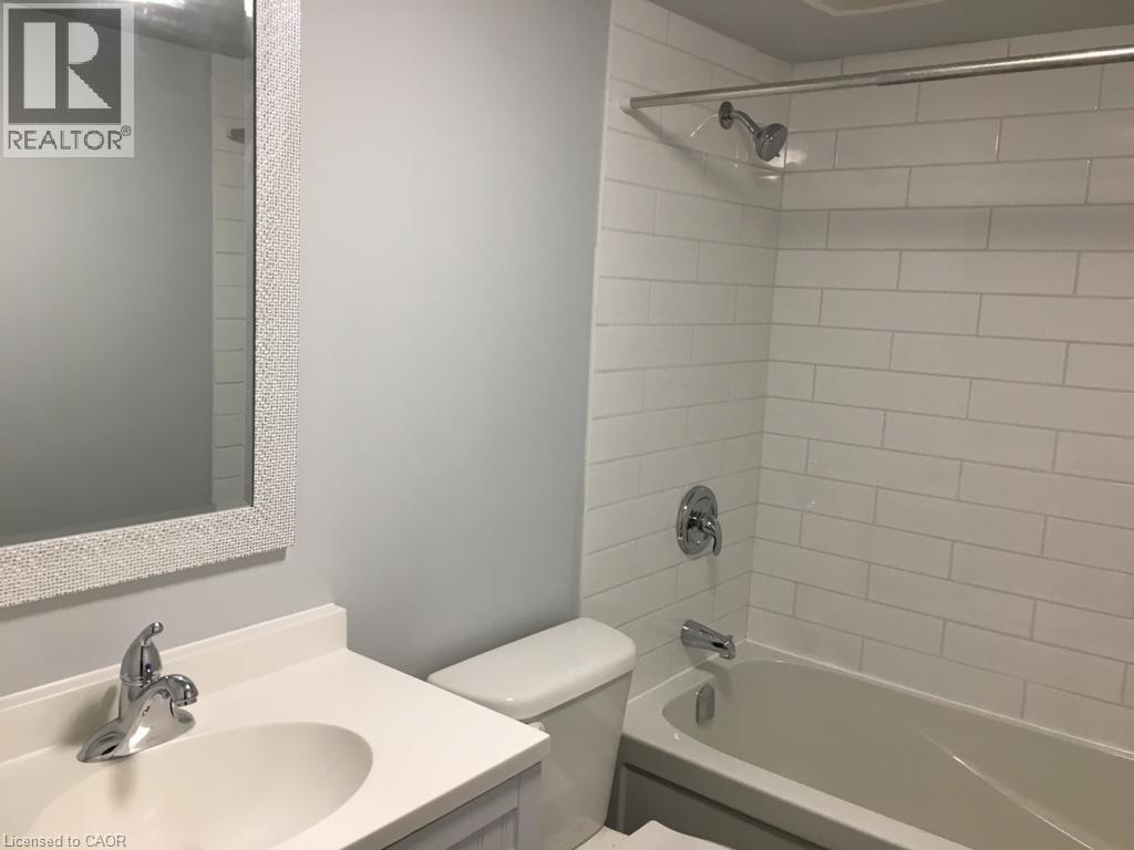 Full bathroom featuring a white subway tile shower, chrome shower fixtures, and a white bathtub - 92 Pattandon Avenue Unit# C, Kitchener, ON - Indoor Photo Showing Bathroom