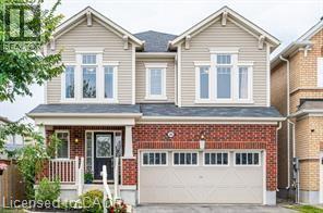 Two-story residence featuring a brick and siding facade with a covered front porch - 386 Apple Hill Crescent, Kitchener, ON