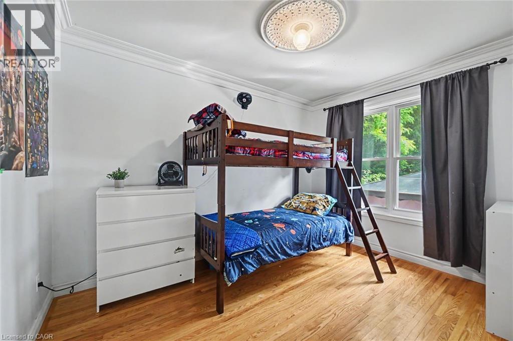 Bright room with wood-finish flooring, a double window, and crown molding - 56 Everton Place, Hamilton, ON
