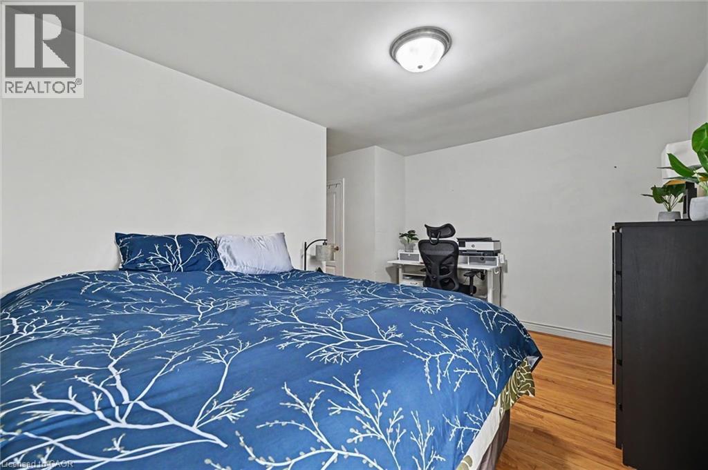 Room featuring light wood-finish flooring, white walls, and a flush-mount ceiling light - 56 Everton Place, Hamilton, ON
