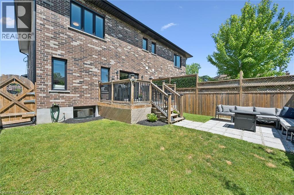Exterior rear elevation with brick cladding and black-framed windows - 63 Plymouth Road, Kitchener, ON