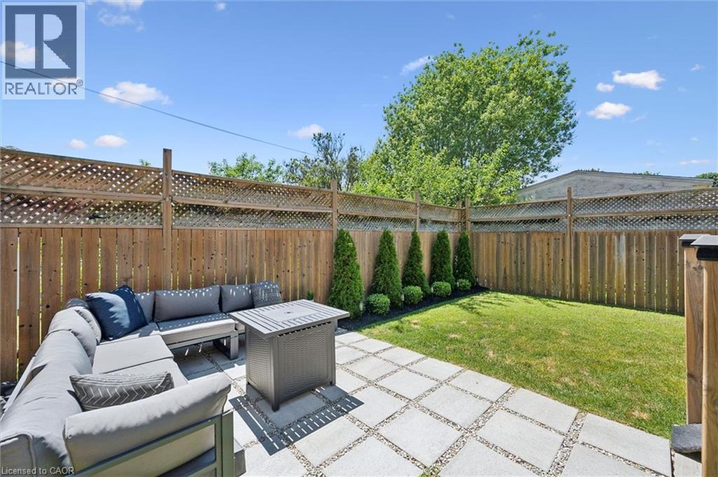 Private backyard with a combination wood and lattice fence - 63 Plymouth Road, Kitchener, ON
