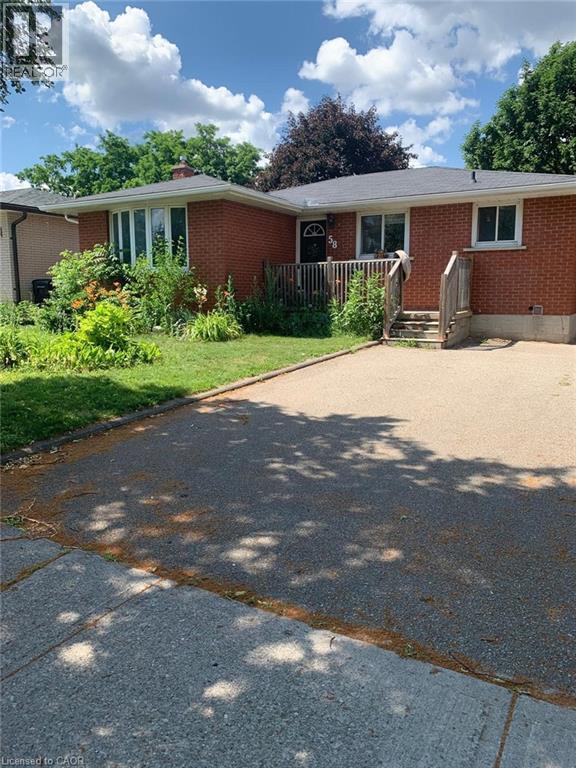 Brick exterior residence featuring a front lawn and paved driveway - 58 Farrier Drive Unit# Basement, Kitchener, ON - Outdoor