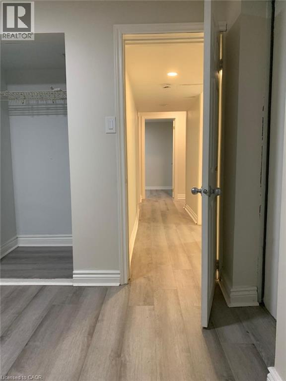 Entryway featuring wood-finish flooring, white baseboards, recessed lighting, and a closet with wire shelving - 58 Farrier Drive Unit# Basement, Kitchener, ON - Indoor Photo Showing Other Room