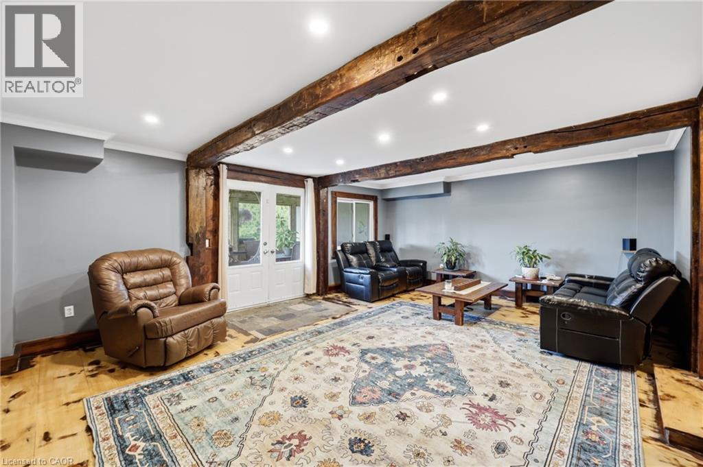 Living space featuring exposed timber beams, recessed lighting, and wood-finish flooring - 97 Smith Road, Hamilton, ON