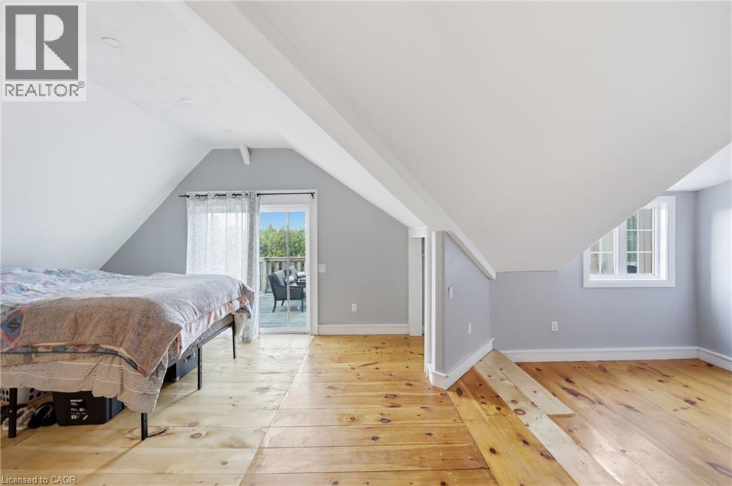 Attic space featuring wood-finish flooring and a white vaulted ceiling - 97 Smith Road, Hamilton, ON