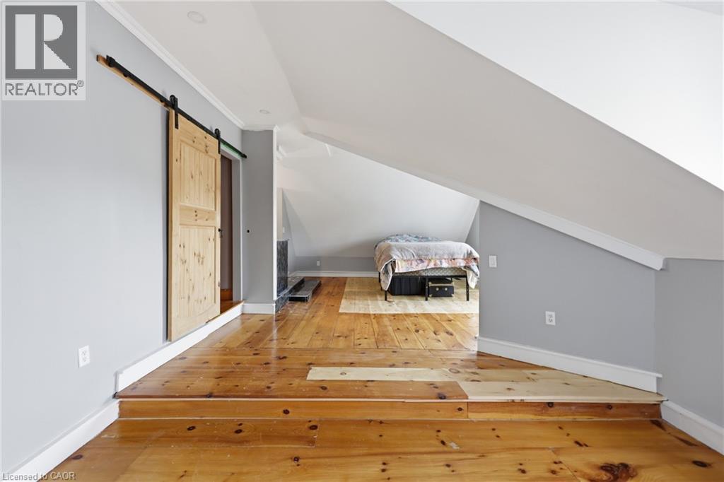 Expansive wood-finish flooring with a two-tier step design - 97 Smith Road, Hamilton, ON